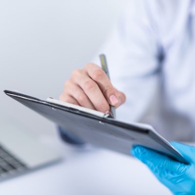 Doctor with tablet writing down notes for concierge care